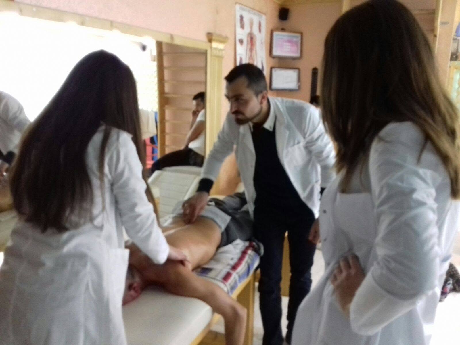 A SHRFPAK physiotherapist demonstrating manual therapy techniques to trainee practitioners
